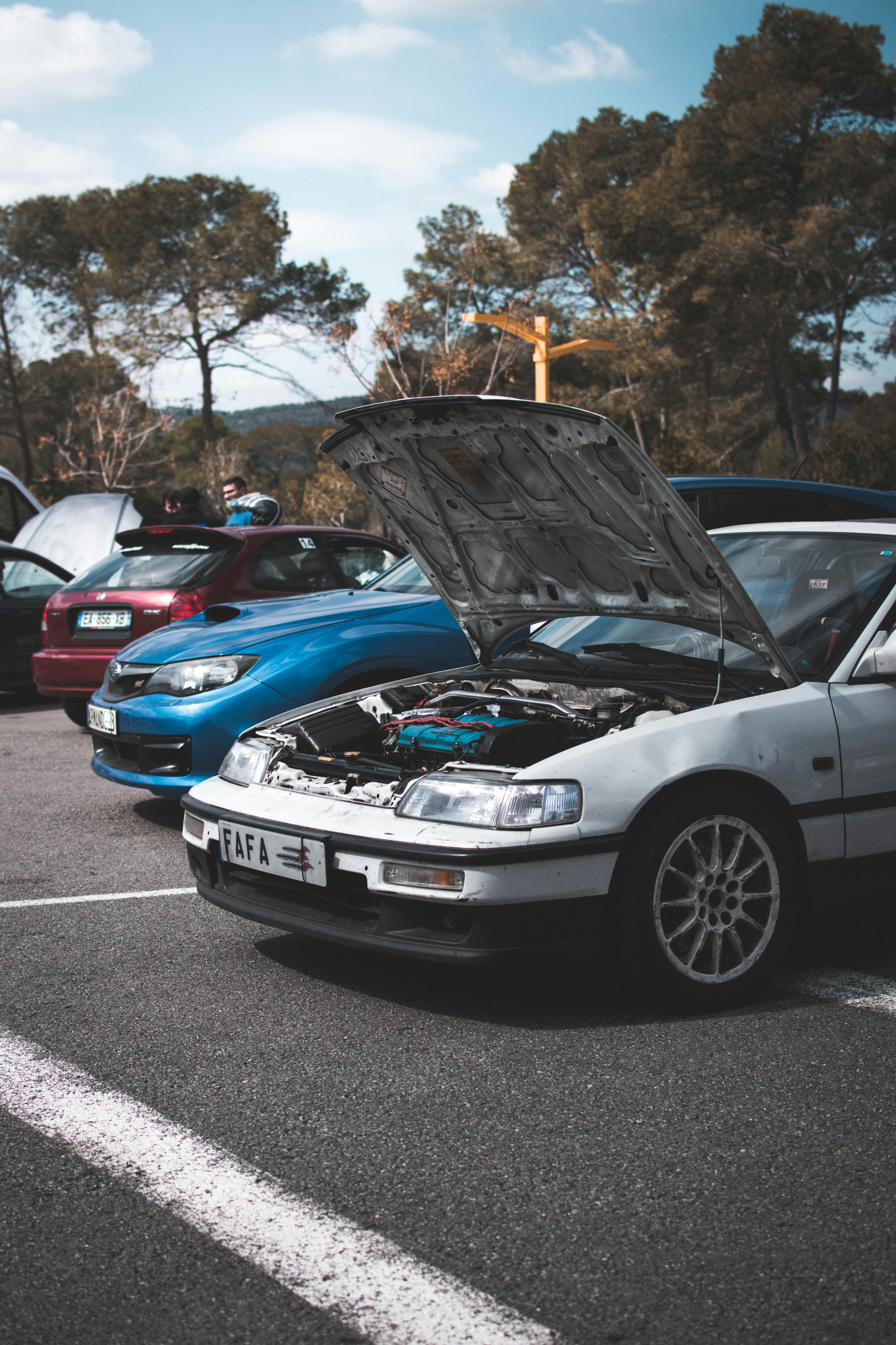 blue bmw m 3 parked on parking lot during daytime